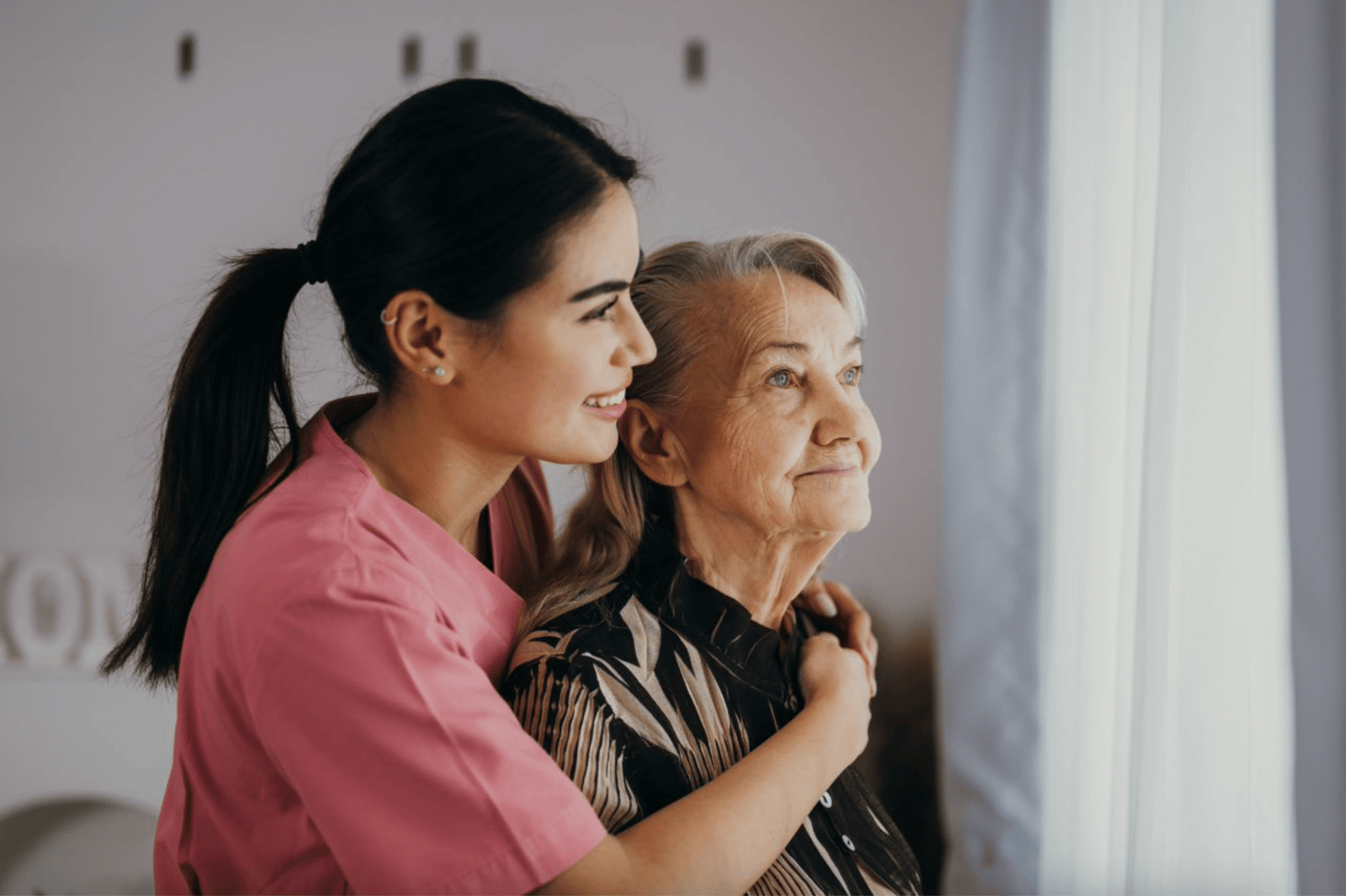 J&M Hope caregiver sitting with a senior client at home in Port St. Lucie, FL