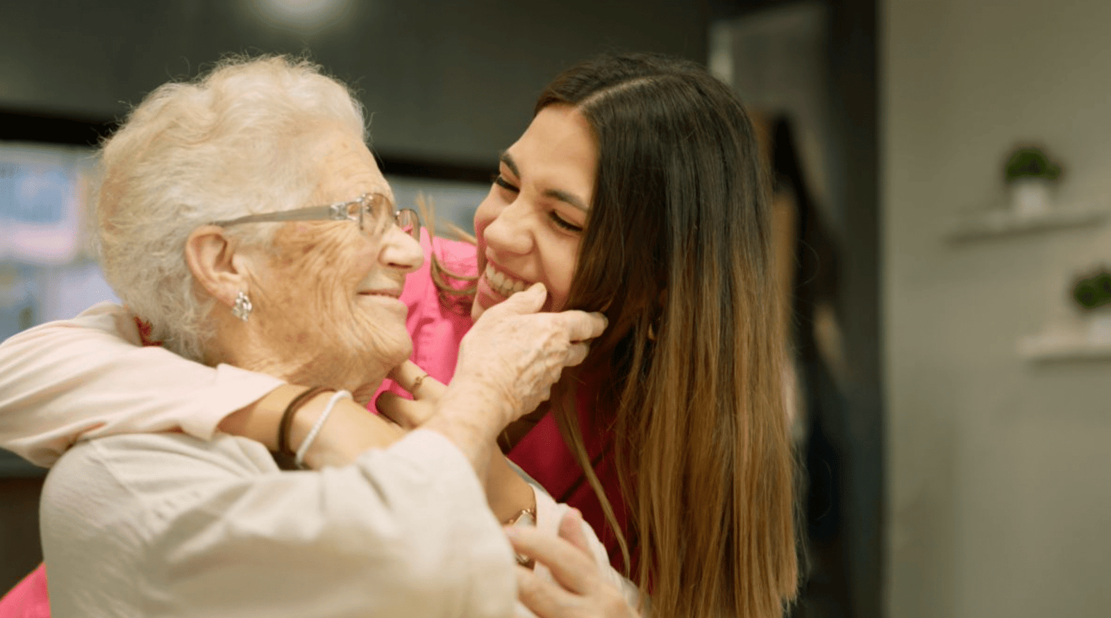 A J&M Hope caregiver sharing a warm moment with a senior client at home on the Treasure Coast