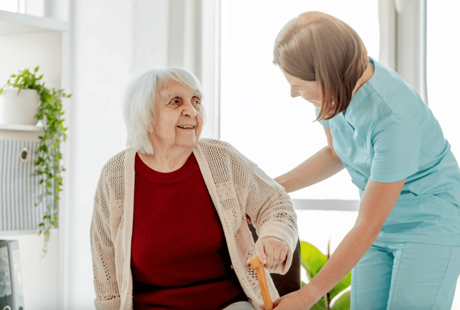 J&M Hope caregiver helping a senior stand at home in Port St. Lucie, FL